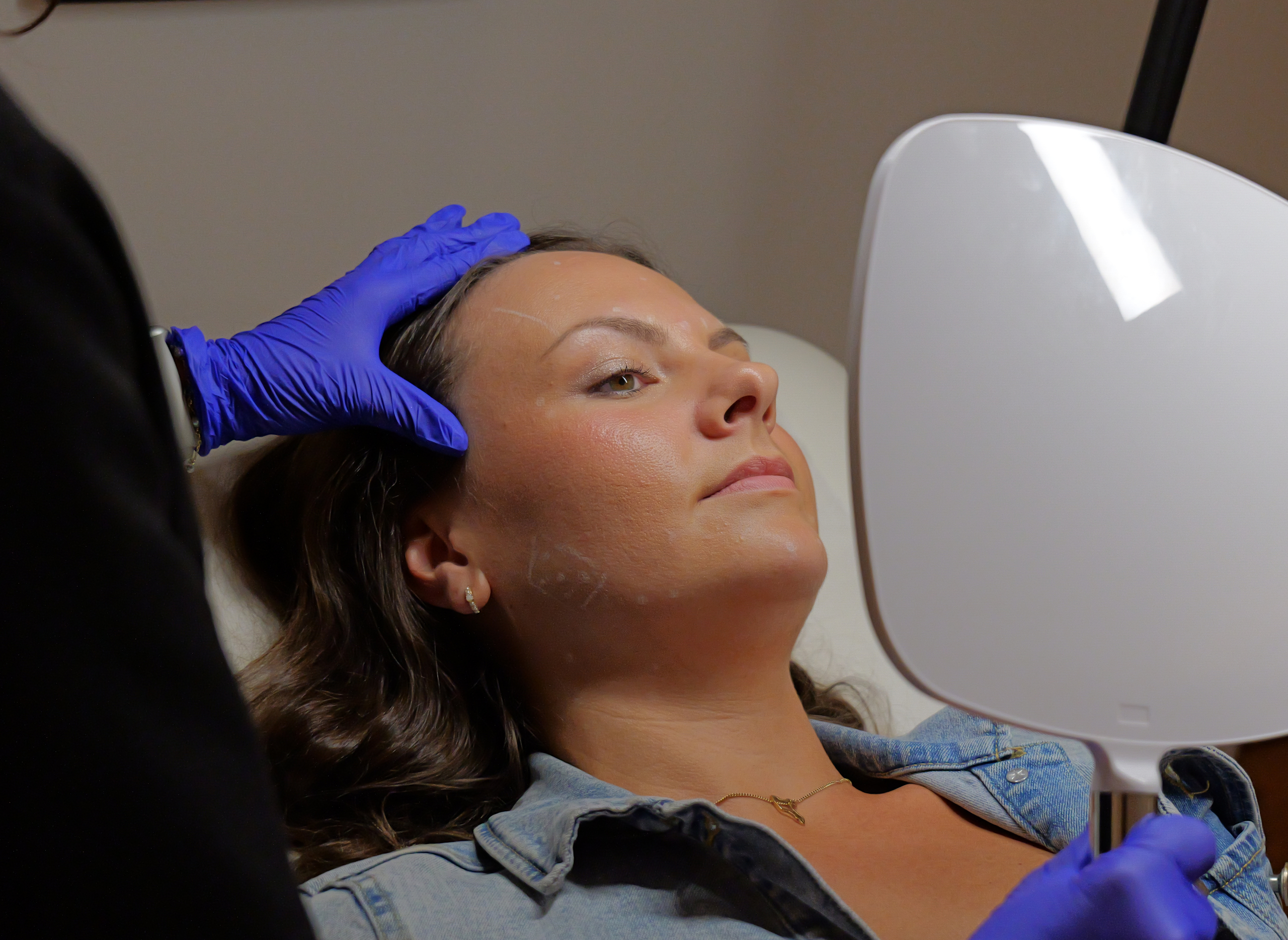 antiwrinkle patient looks in mirror